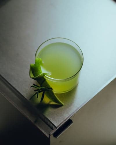 Minimalist Green Cocktail with Rosemary Garnish