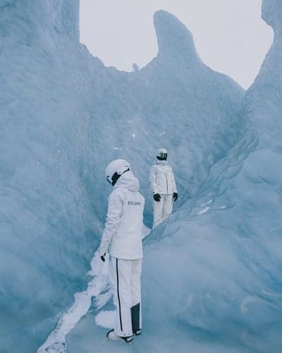 Explorers in a Crystalline Blue Ice Cave