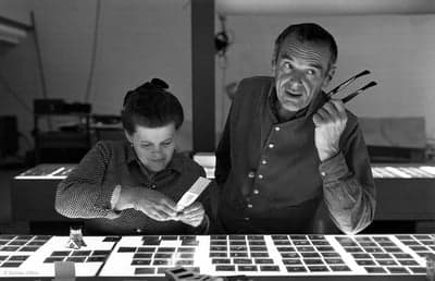 Charles and Ray Eames Reviewing Film Slides
