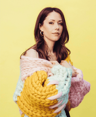 Woman in Oversized Chunky Multi-Color Knit Sweater