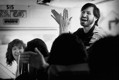 Steve Jobs Laughing and Clapping on a Bus