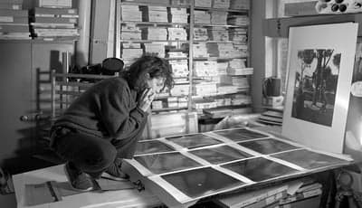 Artist Reviewing Photographic Prints in Archive