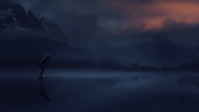 Lone Figure on a Reflective Lake at Twilight