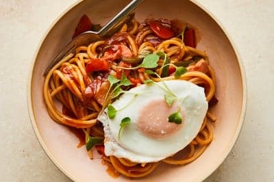 Spaghetti Napolitan with Fried Egg and Microgreens