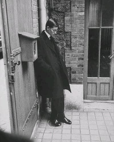 Pensive Man in Overcoat in a Vintage Courtyard