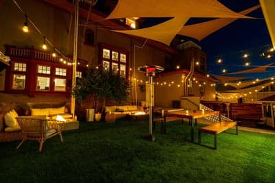 Cozy Nighttime Patio with String Lights and Sun Sails