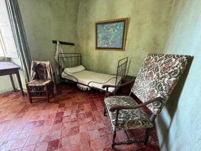 Rustic Historical Bedroom with Iron Bed and Tiled Floor