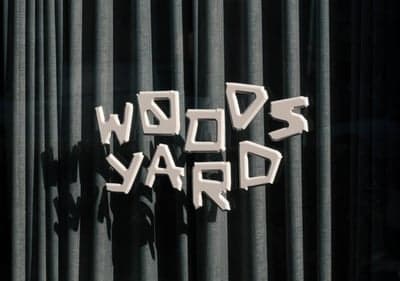 Woods Yard Stylized Signage on Pleated Backdrop